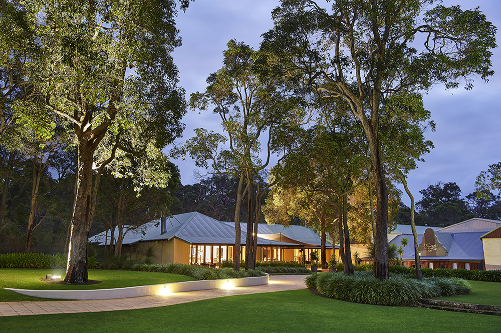 Clairault Streicker Cellar Door and Vineyard Kitchen at twilight between big trees